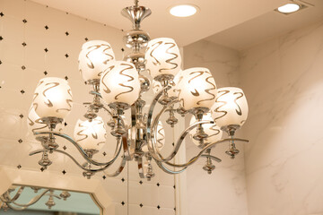 Chrystal chandelier lamp on the ceiling in Dining room Adjusting the image in a Luxury tone .Decorative elegant vintage and Contemporary interior Concept.