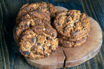 Delicious cookies with pieces of chocolate on the table