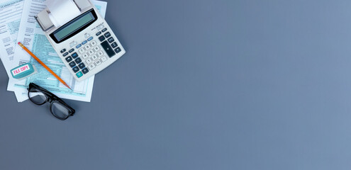 US Individual income tax return with retro items on gray desktop in flat lay format