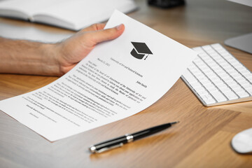Obraz premium Student with acceptance letter from university at wooden table indoors, closeup