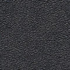 I'm looking at a photo of a piece of leather with a seamless texture. The leather is dyed black and looks soft to the touch. It's smooth surface reflect light in interesting ways.