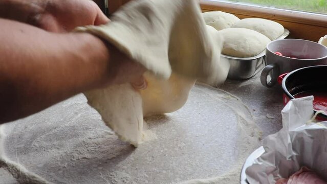 Chef making a pizza dought in the kitchen