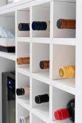 Wine bottles in cellar in modern kitchen