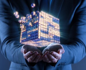 Businessman holding financial cube in business concept