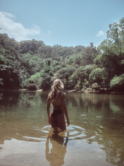 Woman walking in the river