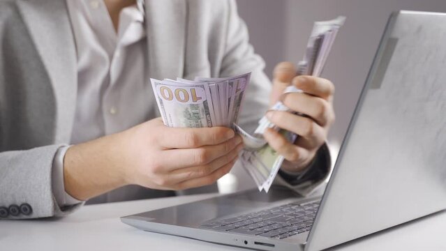 Counting money splitting money. Financial and investments.
Rich man counting dollar bills and looking. Financial and investments.
