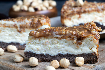 A piece of cheesecake cake with roasted peanuts in caramel
