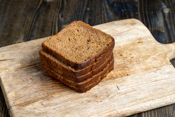 sliced rye bread on a wooden table, close up