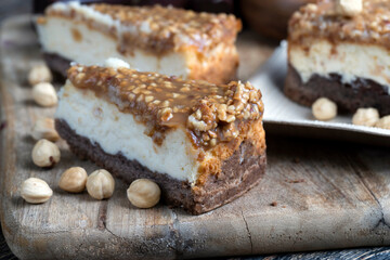 A piece of cheesecake cake with roasted peanuts in caramel