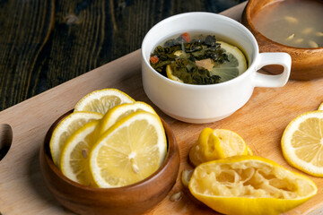 Green tea in a white cup during its brewing