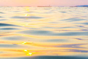 Blurred sea wave on beach sunset light