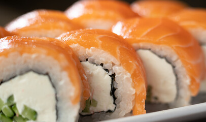Philadelphia sushi roll with salmon on a white plate. japan restaurant menu
