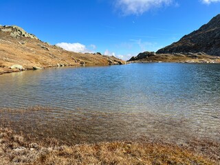 Fototapeta premium Early autumn on the alpine lakes Laghi della Valletta in the mountainous area of the St. Gotthard Pass (Gotthardpass), Airolo - Canton of Ticino (Tessin), Switzerland (Schweiz)