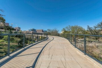Fototapeta na wymiar Bike path at the Waterloo park in Austin Texas against blue sky on a sunny day