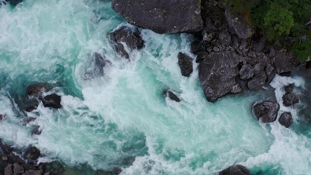 Powerful water cascading over canyon in Norway, rising aerial shot 4K