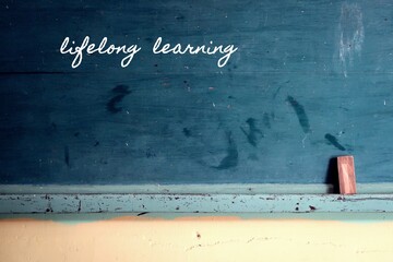 Green vintage school blackboard background with chalkboard written LIFELONG LEARNING