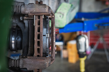 Close-up of car front brake rotors and brake pads.