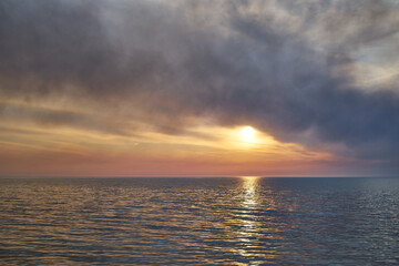 Sea sunset. Smoke wildfires sweeping across the sky.