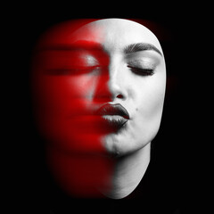 Beauty, fashion and make-up concept. Portrait of a young and beautiful woman with closed eyes sending kiss isolated over black background in red color split effect. Futuristic looking style