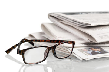 Closeup of Newspapers with Eyeglasses