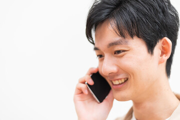 笑顔で携帯を持ち話す日本人男性