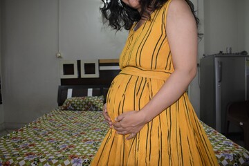 Pregnant woman touching her belly with hands