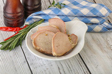 Baked pork tenderloin served rosemary