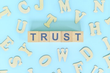 Trust core values concept in business, company and organization. Word typography on wooden blocks flat lay.