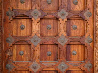 Wooden door on ancient facade wood gate vintage portal wall background