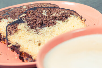 Cup of cappuccino and fresh baked yeast dough with cocoa. Delicious dessert