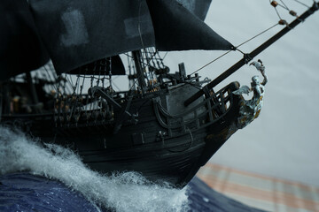 Pirate ship model Black pearl made of plywood, with miniature figures of pirate sailors, close-up...