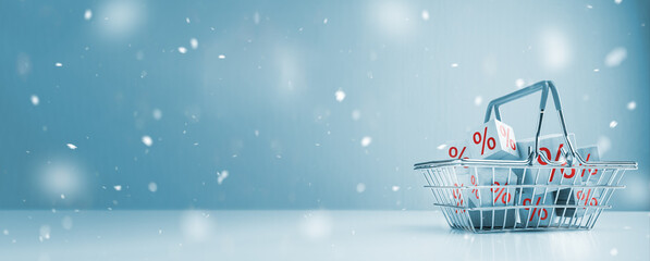 Winter Sale. Shopping basket and red percentage sign and snow effect, Christmas shopping...