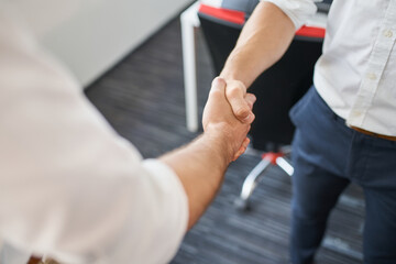 Two businessmen shaking hands at office