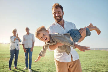 Family, children and playing with a man and son having fun outdoor in a field in nature with...