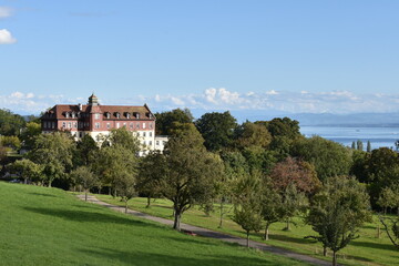 Fototapeta na wymiar Lake Constance Vista with Apple Orchard and Small Castle in Foreground in Early Autumn