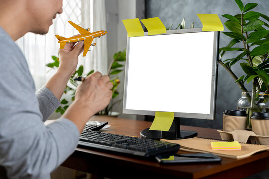 Book Your Tour Online Happy. Male Traveler With Airplane Model Showing Laptop With Blank Screen.