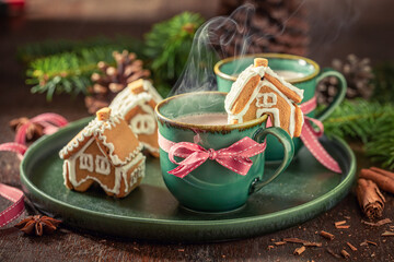 Homemade gingerbread cottages with hot chocolate for Christmas.