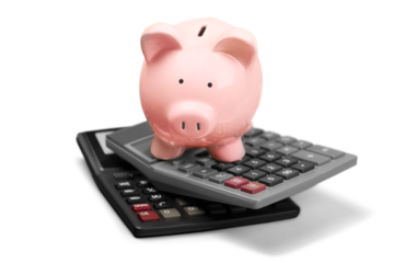 Pink piggy bank standing on calculators on background