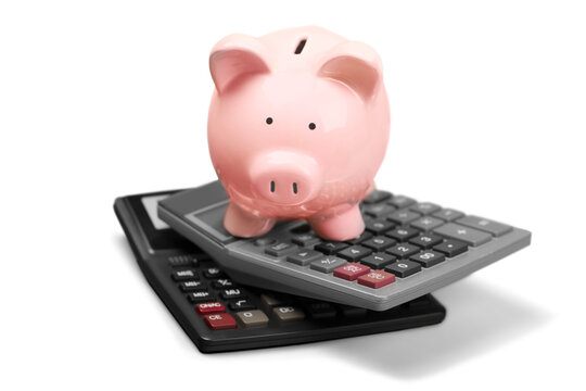 Pink piggy bank standing on calculators on background