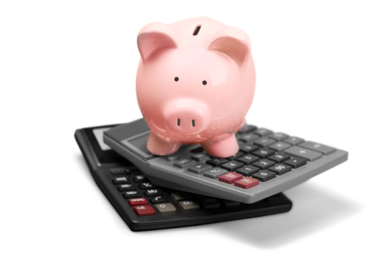 Pink piggy bank standing on calculators on background