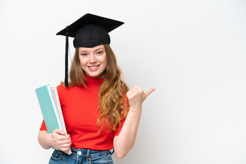 Young university graduate woman isolated on white background pointing to the side to present a...