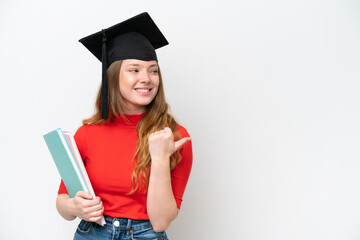 Young university graduate woman isolated on white background pointing to the side to present a...