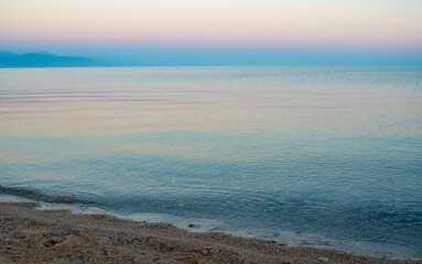 The surface of the water in the Issyk Kul mountain lake in Kyrgyzstan at sunset