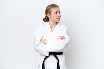 Young caucasian woman isolated on white background doing karate keeping the arms crossed © luismolinero