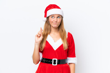 Young caucasian woman dressed as mama noel isolated on white background with fingers crossing and wishing the best