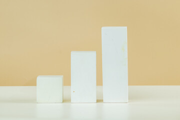 3d rectangular podium of various sizes in white, on a brown and white background