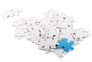 White Puzzle Pieces with One Blue Piece