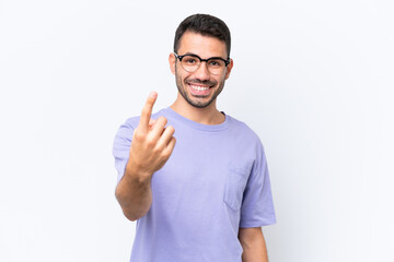 Fototapeta premium Young caucasian man isolated on white background doing coming gesture