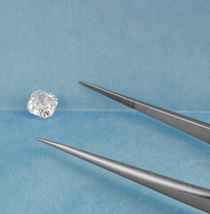Cushion Cut White Diamond on Blue Parcel Background.