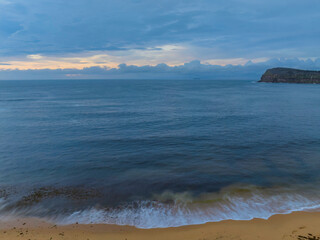Fototapeta premium Pastel cloud covered sunrise seascape